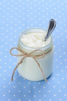 fresh natural yogurt in glass jar, delicious natural yogurt 