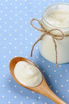 fresh natural yogurt in wooden spoon, delicious natural yogurt 