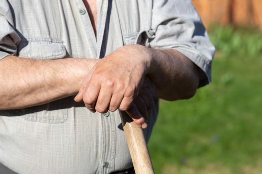 Hands holding a garden tool, farming, gardening, agriculture and people concept