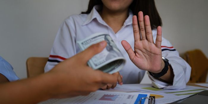 Woman of Commerce Rejecting the contractor's offer of black money in exchange for a permit in the deal. Concepts of corruption and anti-bribery