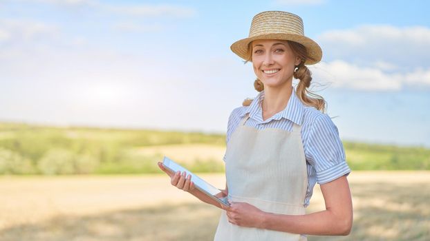 Woman farmer straw hat smart farming standing farmland smiling using digital tablet Female agronomist specialist research monitoring analysis data agribusiness Caucasian worker agricultural field