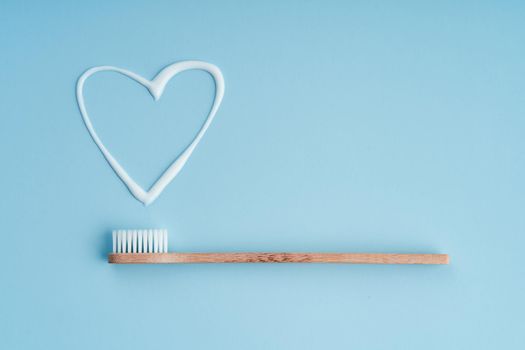 Eco-friendly trendy bamboo toothbrush. Popular toothbrushes. Hygiene trends. Top view with toothpaste.