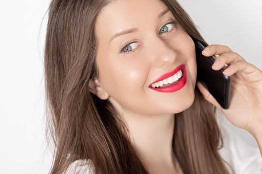 Happy smiling woman calling on smartphone, portrait on white background. People, technology and communication concept.