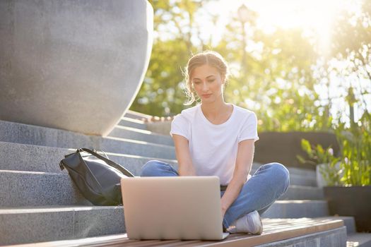 Businesswoman sitting stairs summer park using laptop Business persone working remote. Outdoor Successful european caucasian woman freelancer make video call teacher study work online lessons