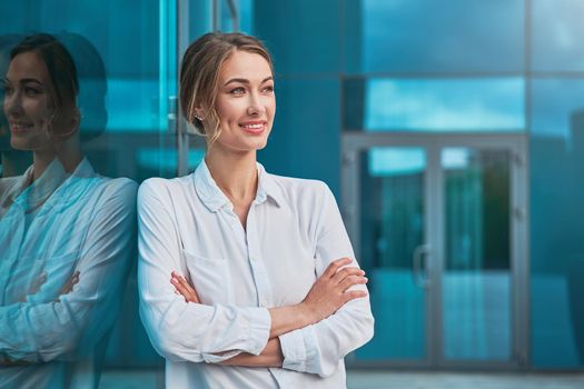 Businesswoman successful woman business person standing arms crossed outdoor corporate building exterior Smile happy caucasian confidence professional business woman middle age female entrepreneur