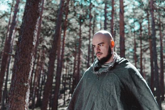 Viking with an angry look on his face in a Norwegian forest.