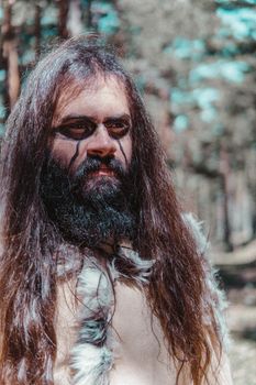 Viking with war paintings in a Norwegian forest