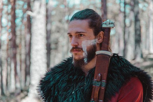 Viking with war paintings in a Norwegian forest