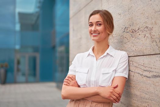 Businesswoman successful woman business person standing arms crossed outdoor corporate building exterior Smile happy caucasian confidence professional business woman middle age female entrepreneur