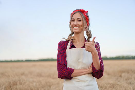 Woman farmer standing farmland smiling Female agronomist specialist farming agribusiness Happy positive caucasian worker agricultural field dressed red checkered shirt and bandana showing thumb up