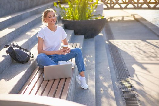 Businesswoman sitting stairs summer park using laptop Business persone working remote. Outdoor Successful european caucasian woman freelancer make video call teacher study work online lessons