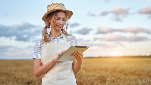 Female agronomist specialist research monitoring analysis data agribusiness Woman farmer straw hat smart farming standing farmland smiling using digital tablet Caucasian worker agricultural field