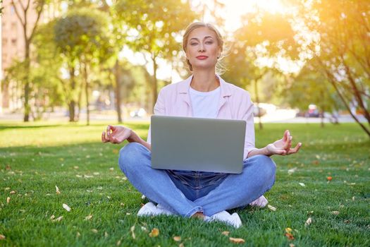 Businesswoman sitting grass summer park using laptop Business person working remote. Outdoor Successful european caucasian woman freelancer make video call teacher study work online lessons