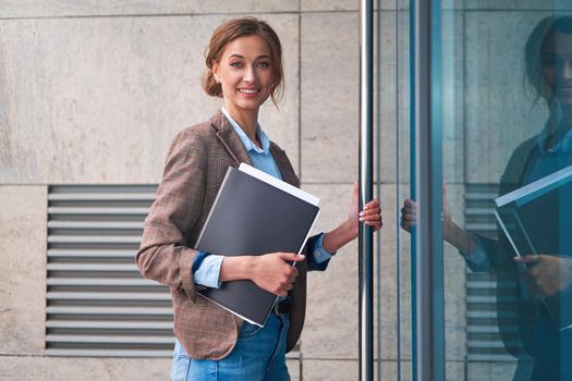 Businesswoman successful woman business person open door small business new opportunities Caucasian professional business woman documents Bank worker open door new opportunities concept interview