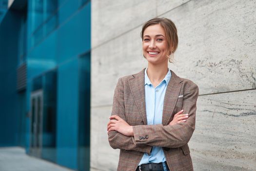 Businesswoman successful woman business person standing arms crossed outdoor corporate building exterior Smile happy caucasian confidence professional business woman middle age female entrepreneur