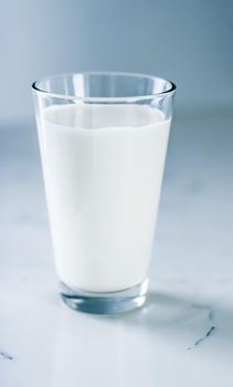 Dairy, healthy nutrition and breakfast concept - World Milk Day, full glass on marble table