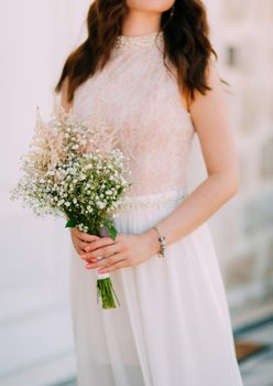 Wedding bridal bouquet of Gypsophila in the hands of the bride. Wedding in Montenegro.