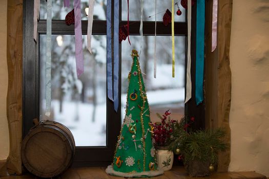 New Year's still-life. Christmas tree handmade Ukrainian tapes. Dress up the tree with a bagel. Christmas decorated window