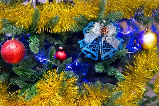New Year's background. Christmas tree with tinsel toys and bells