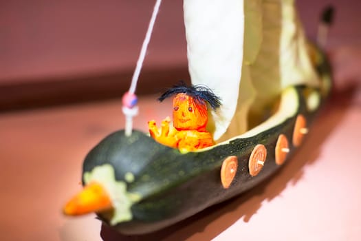 A ship and a sailor made of squash and carrots