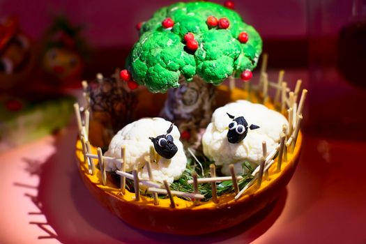 Sheep on the farm and a green tree made from broccoli and cauliflower