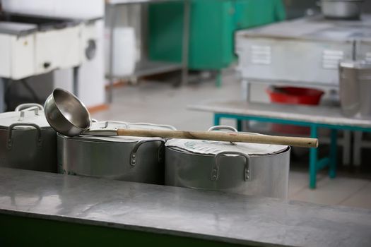 Large iron pans and a ladle