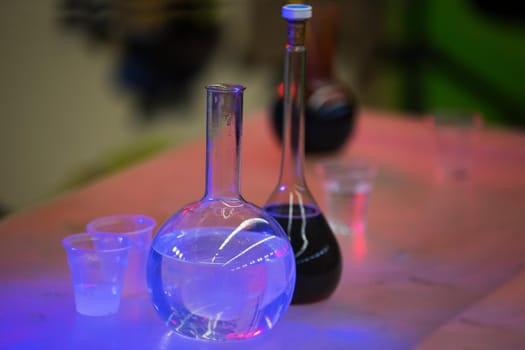 Glass bulbs in blue lighting for experiments.Test flasks