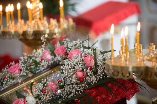 Orthodox altar with candles decorated with flowers