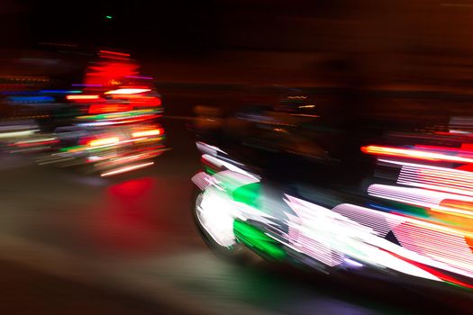 Blurred background riding a motorcycle. Motion bike in multi-colored lights