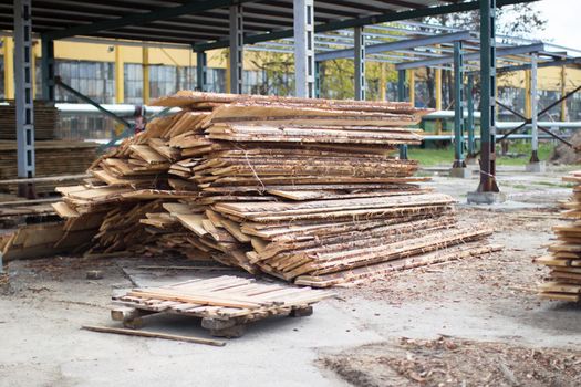 Woodworking industry. A pile of untreated wooden boards.Wood in production