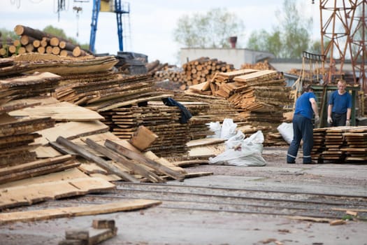 Belarus, the city of Gomel, on April 26, 2018. Furniture factory. Open Day. Heap of logs and wooden boards, sawn trees on woodworking production.Wood in production