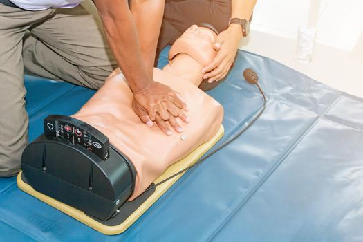 CPR aid dummy medical training with hand press Heart on doll emergency refresher training Concept closed-up.