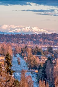 Empty city street in sunset light with mountain Baker on the background.