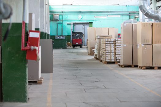 Belarus, the city of Gomel, on April 26, 2018. Furniture manufacturing. Warehouse with cardboard boxes and a forklift truck