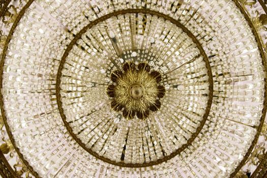 Crystal chandelier close-up. Fragment of the rich theatrical chandelier