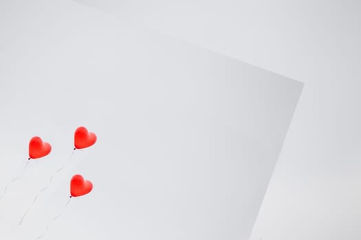 Gray background greeting card with red inflatable balls