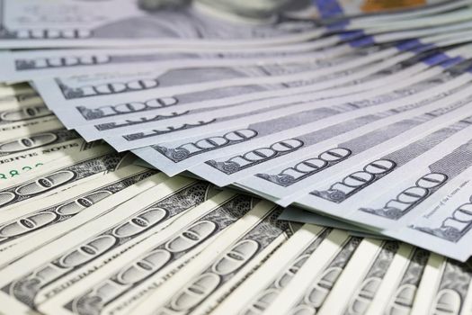 One hundred dollar bills folded in a fan. A lot of dollars