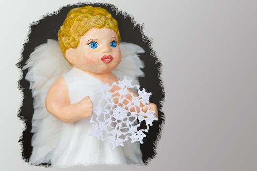 Doll angel with a knitted snowflake close-up