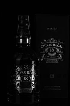 Chivas Regal 18 is blended from whiskies matured for at least 18 years. Whisky bottle on barrel. Illustrative editorial photo Bucharest, Romania, 2021