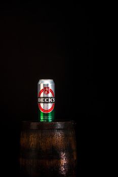 Can of Becks beer on beer barrel with dark background. Illustrative editorial photo Bucharest, Romania, 2021