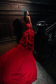 Woman Vintage Red Dress Old Castle Beautiful Princess In Seductive Dress Elegant Caucasian Female Fairy Tale story Dark Stairs