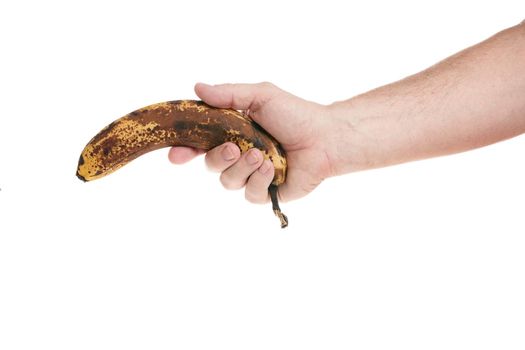 Hand holds a ripe banana on a white background, template for designers. Close up