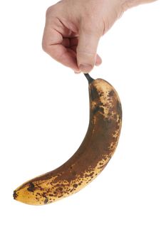 Hand holds a ripe banana on a white background, template for designers. Close up