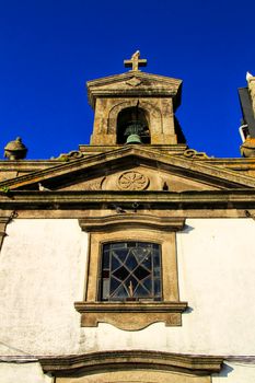 Beautiful and old facade of an old parish on the banks of the Douro river in Oporto, Portugal
