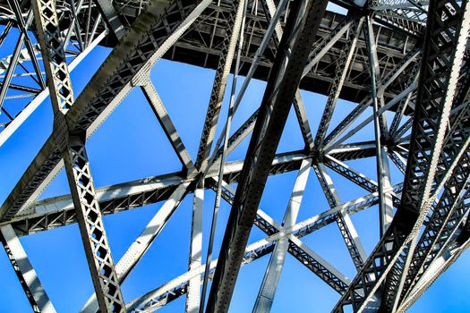Structure of the Beautiful and colossal iron bridge called Dom Luis I over the waters of the Douro River in Porto