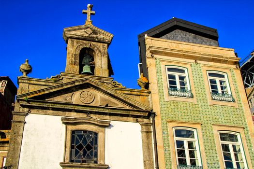 Beautiful and old facade of an old parish on the banks of the Douro river in Oporto, Portugal