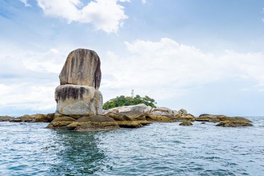 Beautiful nature landscape of Ko Hin Sorn small island with surprisingly overlap rocks in the Andaman Sea and sky in summer attractions near Koh Lipe at Tarutao National Park, Satun, Thailand