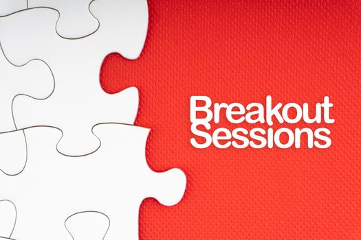BREAKOUT SESSIONS text with jigsaw puzzle on red background. Business and Motivation Concept