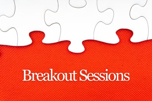 BREAKOUT SESSIONS text with jigsaw puzzle on red background. Business and Motivation Concept
