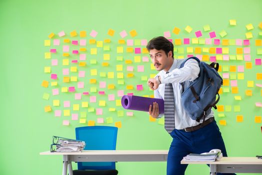 Man in the office with many conflicting priorities preparing go for training